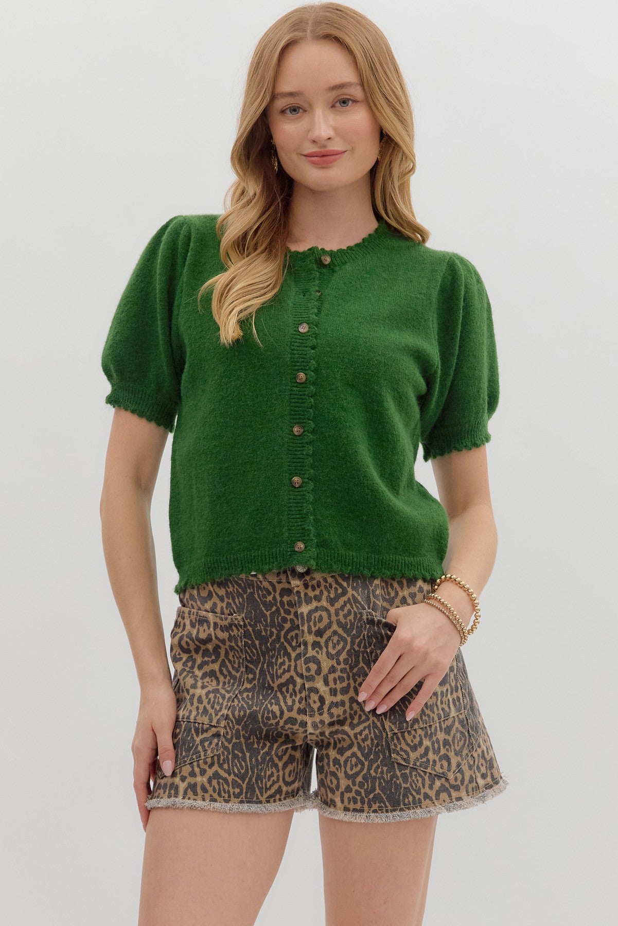 Solid short puff sleeve sweater knit top featuring scallop accent edge
